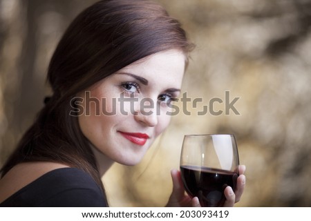 Elegant glamour woman in restaurant with glass of red wine