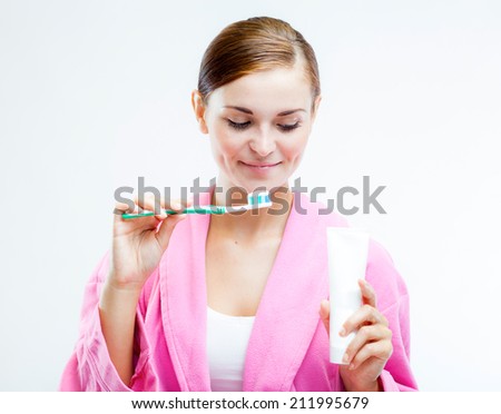 Beautiful woman with toothbrush and tooth paste tube, dental care concept