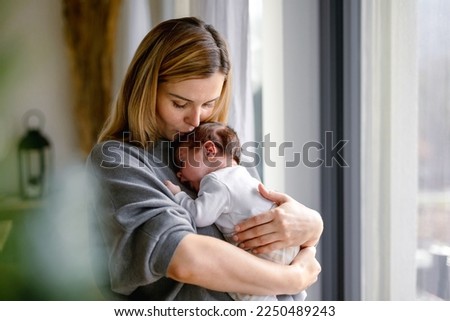 Similar – Image, Stock Photo A young mother and her little daughter together water the plants in the greenhouse. Childhood, parenting, upbringing