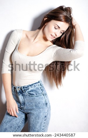 Young beautiful woman with long hair in high waisted vintage jeans