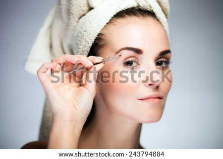 Beauty fresh model girl shaping eyebrows with tweezer