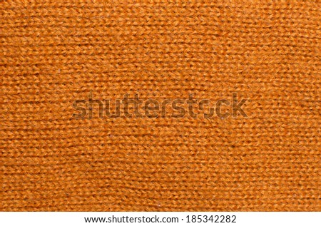 Orange wool knit work. Orange wool knit work full frame for warming winter texture, backdrop or background.