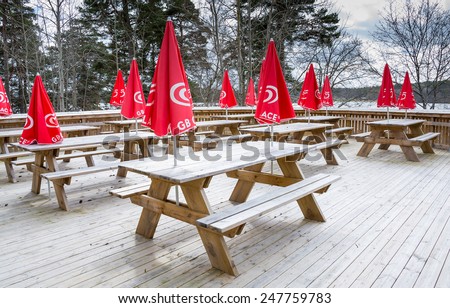 KANAAN, STOCKHOLM, SWEDEN - APRIL 13, 2014: Red parasols with icecream logos outdoors in the spring, Kanaan minigolf cafe, on April 13, 2014 in Stockholm, Sweden.