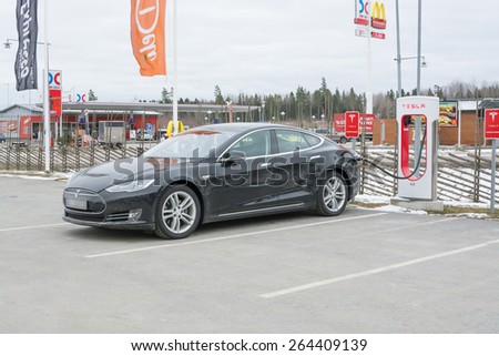 ARBOGA, SWEDEN - MARCH 22, 2015: Tesla power charger. Tesla Motors Inc, electric car being charged in one of the stations between Stockholm and Oslo on March 22, 2015 in Arboga, Sweden.