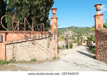 SOLLER, MALLORCA, SPAIN - FEBRUARY 7, 2013: Entrance sign at the Ca N\'ai rural hotel with traditional drystone rocks, black and gold sign on February 7, 2013 in Soller, Mallorca, Spain.
