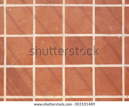 Terracotta floor square tile background texture.