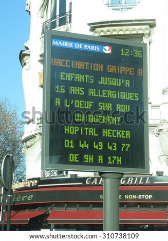 PARIS, FRANCE - JANUARY 5, 2010: LED information board with message regarding bird flu vaccination for allergic children from the Paris Mayor\'s office on January 5, 2010 in Paris, France.