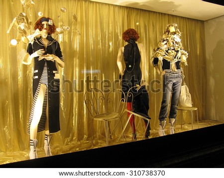 PARIS, FRANCE - JANUARY 3, 2010: Christmas window high fashion display beautifully lit at night in the Printemps department store on January 3, 2010 in Paris, France.