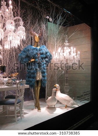 PARIS, FRANCE - JANUARY 3, 2010: Christmas window high fashion display by Philippe Ferrandis beautifully lit at night in the Printemps department store on January 3, 2010 in Paris, France.