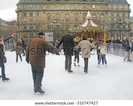 PARIS, FRANCE - JANUARY 2, 2010: People iceskating and people watching near Hotel de Ville on January 2, 2010 in Paris, France.