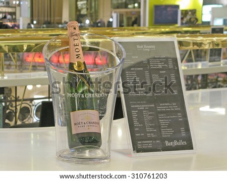 PARIS, FRANCE - JANUARY 5, 2010: A bottle of Moet & Chandon champagne in the  famous department store Galeries Lafayette with architecture from La Belle Epoque on January 5, 2010 in Paris, France.