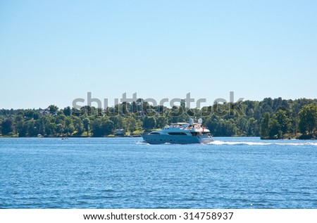 STOCKHOLM, SWEDEN - AUGUST 14, 2015: Yacht speeding on Lake Malaren on a sunny summer day on August 14, 2015 in Bromma, Stockholm, Sweden.
