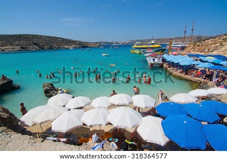 BLUE LAGOON, COMINO, MALTA - SEPTEMBER 16, 2015: Visitors crowd to enjoy the clear turquoise water of popular tourist attraction Blue Lagoon on September 16, 2015 in Comino island, Malta.