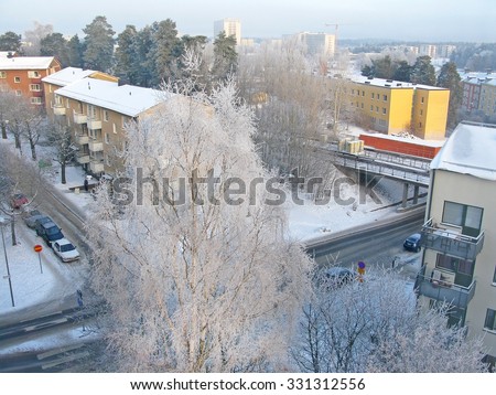 BLACKEBERG, STOCKHOLM, SWEDEN - DECEMBER 2, 2010: Winter landscape with parked cars, snowy roof tops and snow on the railway track on December 2, 2010 in Blackeberg, Stockholm, Sweden.