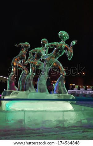 PERM, RUSSIA - JAN 11, 2014: Illuminated sculpture three figure skaters at evening in Ice town, created in honor of Winter Olympic Games 2014 will be in Sochi, Russia.