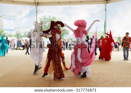 PERM, RUSSIA - JUN 15, 2014: People in costume dancing on street theaters show at open air festival White Nights