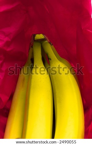 Bananas in a banana basket with a red background