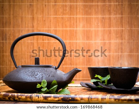Moroccan mint tea pot, cup and leaves