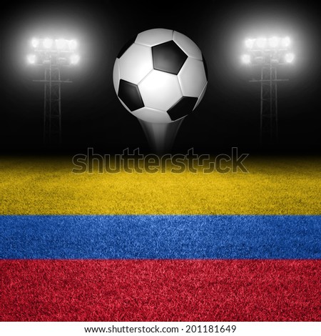 Soccer ball above colombian flag field against illuminated stadium lights