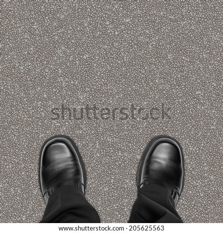 Business man feet on road asphalt, overhead view