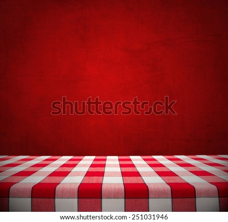 Red checkered tablecloth on dining table against red chalkboard, valentine background