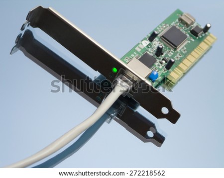 Access online concept with ethernet network interface, attached cable and green lit led light on reflective surface