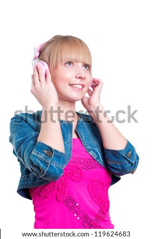 Young attractive woman listing to music with headphones against white background