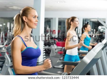 young women running on a treadmill, exercise at the fitness club