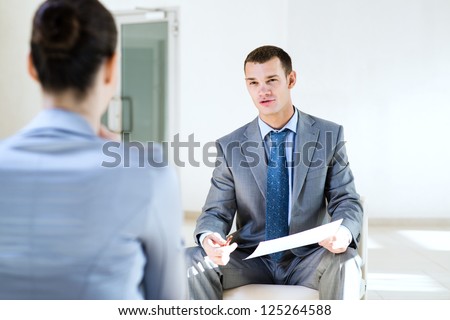 Businessman talking to a woman for a job, interviewing