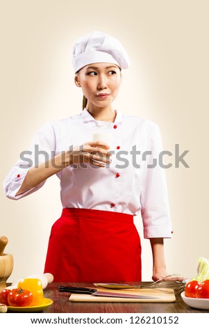 Asian female cook drinking milk and has a milk mustache