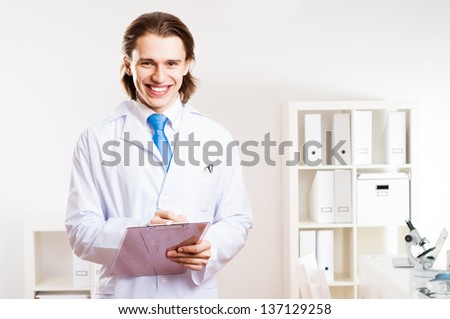portrait of a doctor with a clipboard takes notes