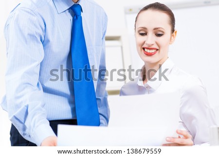 colleagues discuss the reports at a desk in the office, working together in business