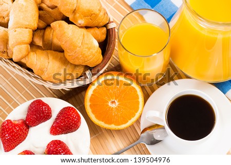 continental breakfast: coffee, strawberry and cream, croissant and juice
