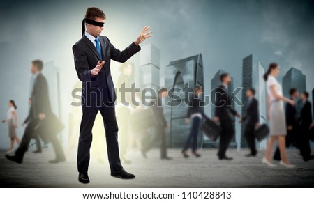 young blindfolded man. his arms and looking for a way out
