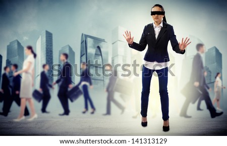 young blindfolded woman. seeking a way out in a crowd