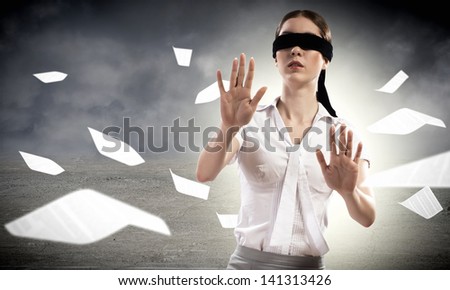 young blindfolded woman. can not find a way out