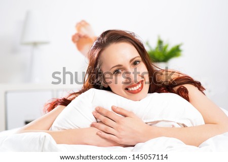portrait of a young woman lying in the bedroom and rest