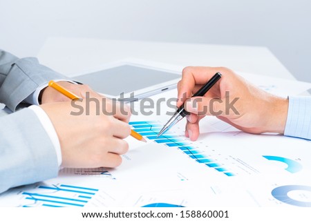 business people discuss meeting targets, sitting at the business table with documents