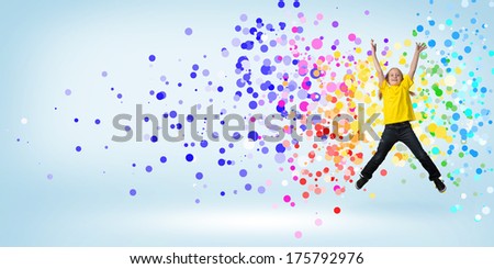 funny girl jumping around colored dots and rays of light