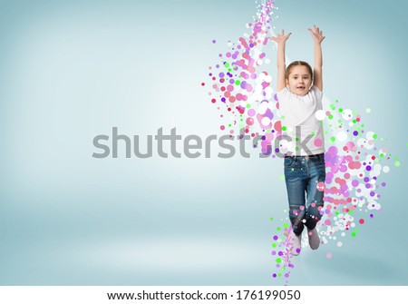 funny girl jumping around colored dots and rays of light