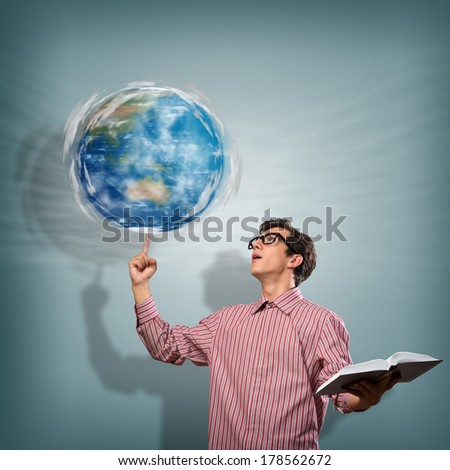 young man with a book thinks. keeps the finger symbol of the planet Earth. NASA images used