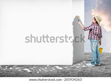 Cute little boy with paint brush in hand