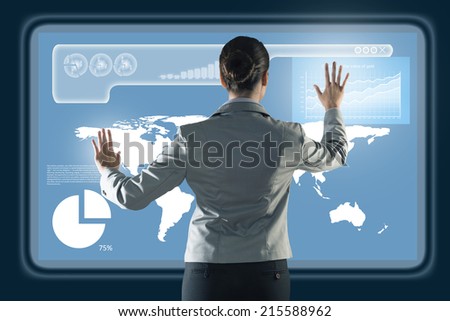 businesswoman working with modern virtual technologies, stands back, hands touching the screen