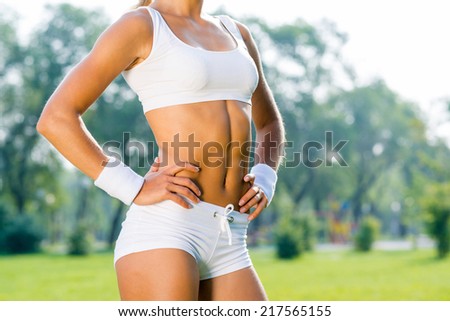 young woman goes in for sports in the summer park
