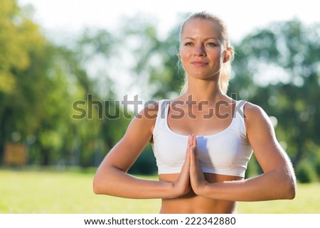 young attractive woman doing yoga in the park, active lifestyle