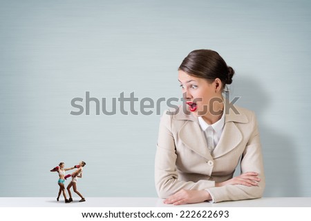 Attractive businesswoman and miniatures of two boxing women