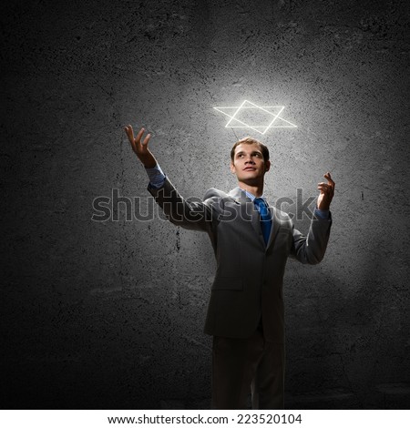 Young handsome businessman and six pointed star above head