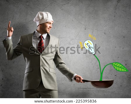 Handsome emotional businessman with pan in hands