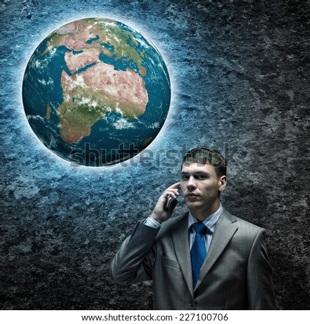 Young businessman looking thoughtfully at Earth plane. Elements of this image are furnished by NASA