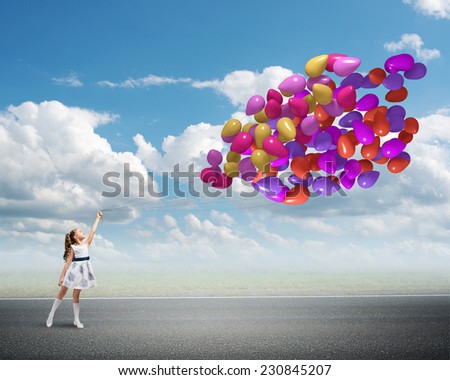 Cute girl of preschool age with bunch of balloons